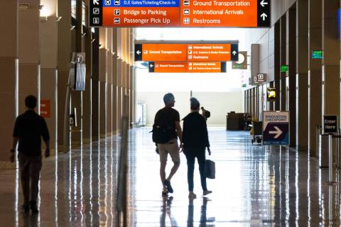 Passengers walk at Terminal 3 at Harry Reid International Airport on Friday, June 24, 2022, in ...