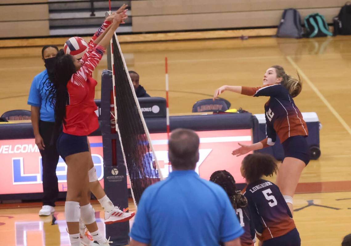 Legacy's Jeya Dupris (12) sends the ball past a Liberty player during a volleyball game at Lega ...