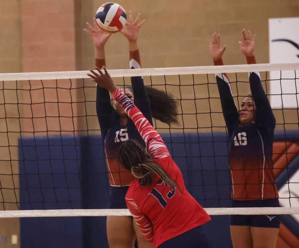 Legacy's Siunipa Mauga (15) reaches to hit the ball as Liberty's Amaya Tobias (13) looks to def ...