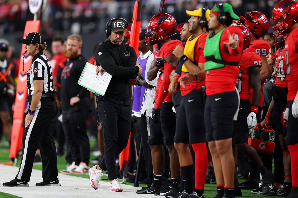 UNLV Rebels head coach Marcus Arroyo walks the sideline during the second half of a NCAA footba ...