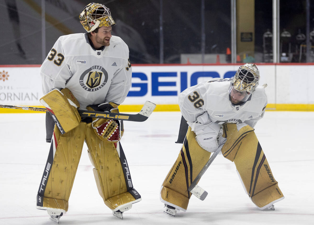 Golden Knights goaltender Adin Hill (33) and goaltender Logan Thompson (36) skate off the ice d ...