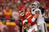 Kansas City Chiefs quarterback Patrick Mahomes (15) is sacked by Las Vegas Raiders defensive en ...