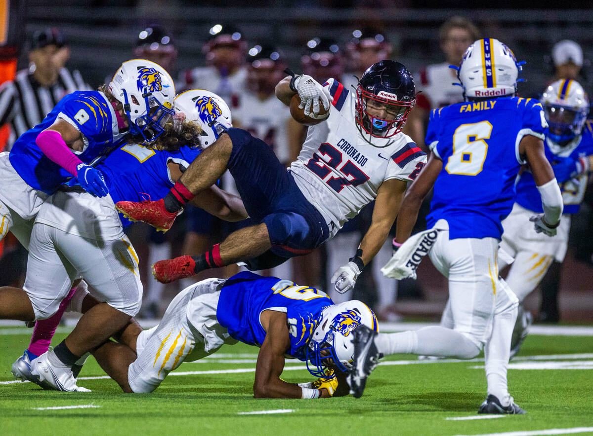 Coronado RB Mohammad Maali (27) is upended after a long run by Sierra Vista DB Giovanni Muscari ...