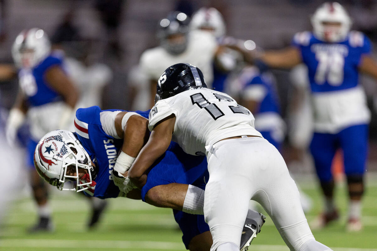 Desert Pines’ Landon McComber (15) tackles Liberty’s Jayden Robertson (7) during ...