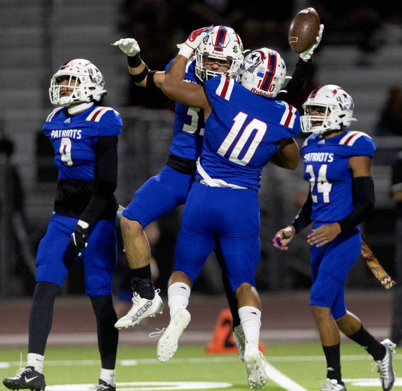 Liberty’s Ryden-James Dacosin (33), after catching an interception, jumps to celebrate w ...