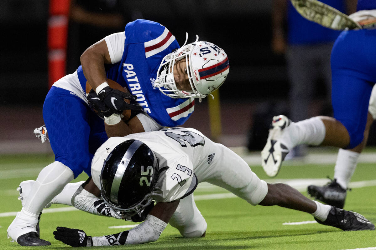 Desert Pines’ Jaylen Allen (25) tackles Liberty’s Isaiah Lauofo (3) during a Clas ...