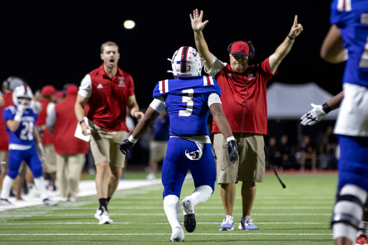 Liberty’s Isaiah Lauofo (3) runs to hug head coach Rich Muraco, right, after he caught a ...