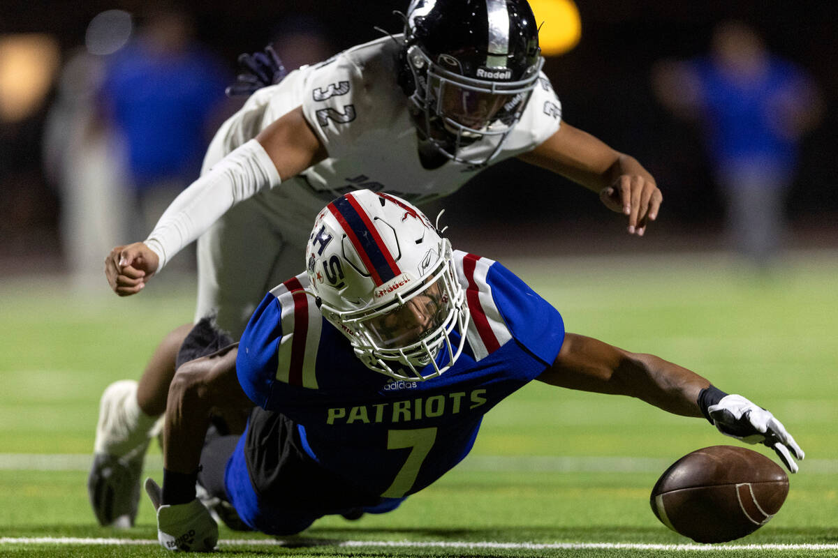 Liberty’s Jayden Robertson (7) attempts to recover a catch he fumbled while Desert Pines ...