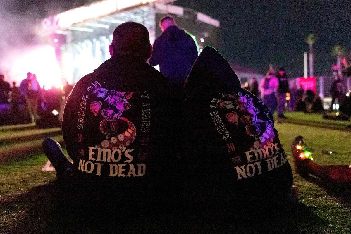 Attendees of the When We Were Young music festival wear clothing reading “emo’s n ...