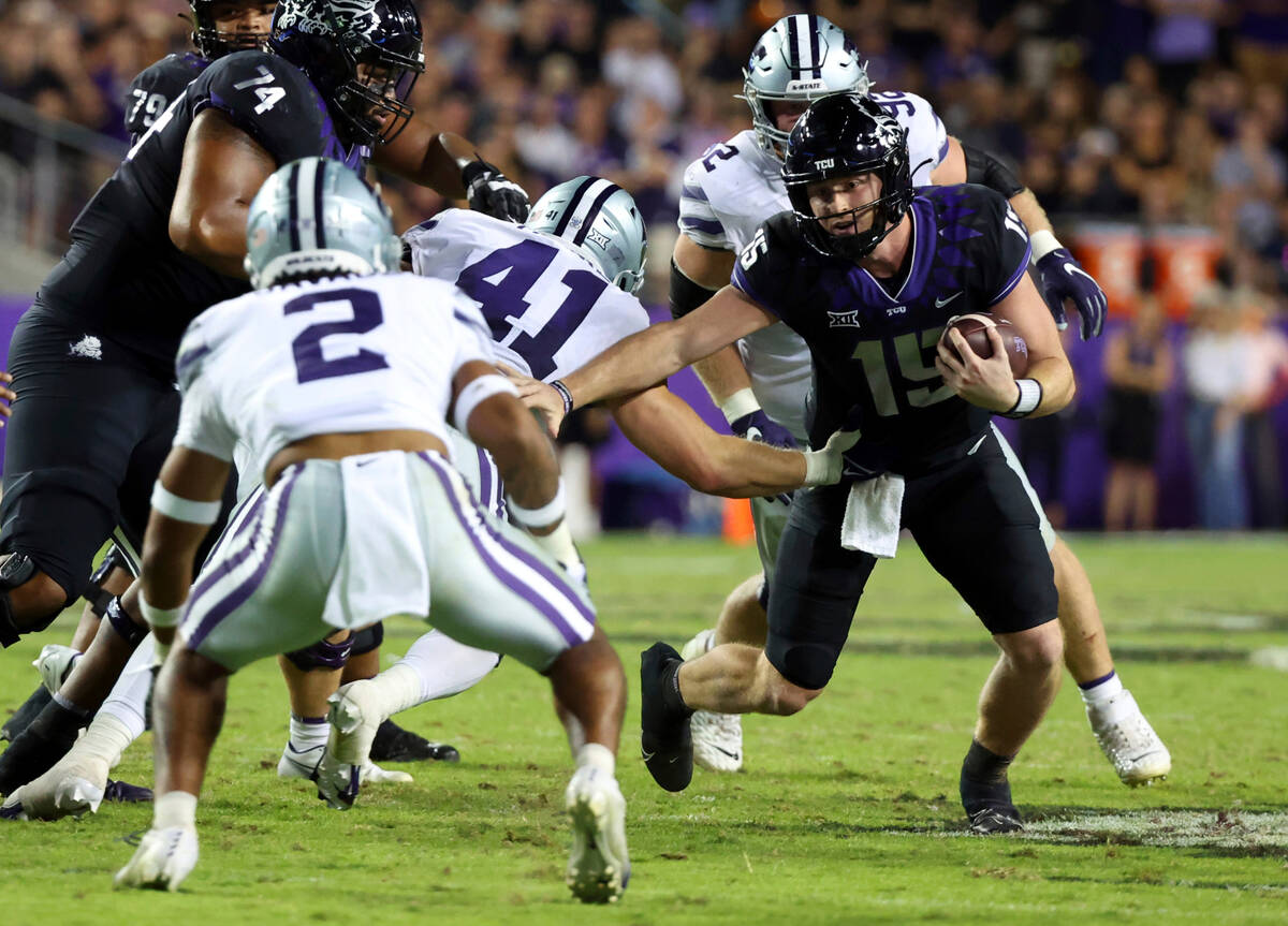 TCU quarterback Max Duggan (15) tries to evade tackle by Kansas State linebacker Austin Moore ( ...