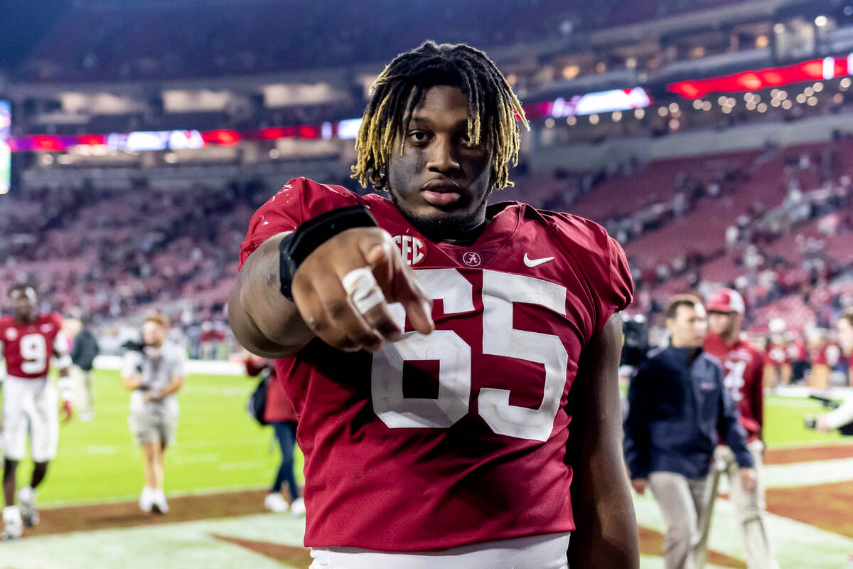 Alabama offensive lineman JC Latham (65) walks off the field after the team's NCAA college foot ...