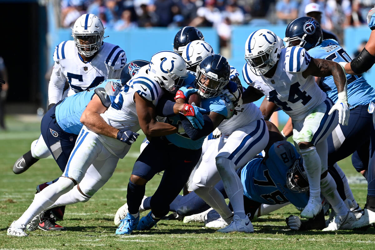 Tennessee Titans running back Derrick Henry (22) runs with the ball during the first half of an ...