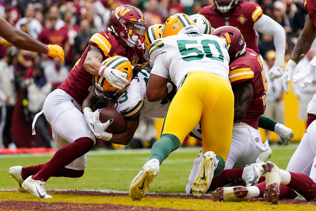 Green Bay Packers running back Aaron Jones (33) scores a touchdown as Washington Commanders cor ...