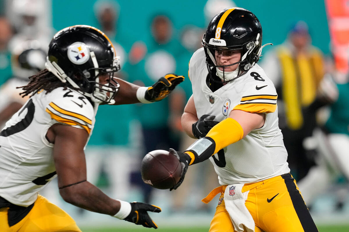 Pittsburgh Steelers quarterback Kenny Pickett (8) hands the ball to running back Najee Harris ( ...