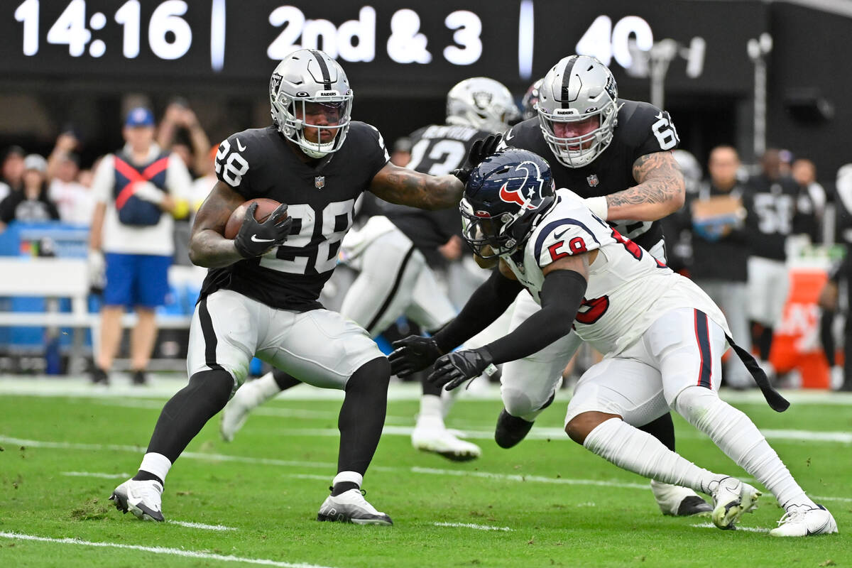 Las Vegas Raiders running back Josh Jacobs runs with the ball during the first half of an NFL f ...