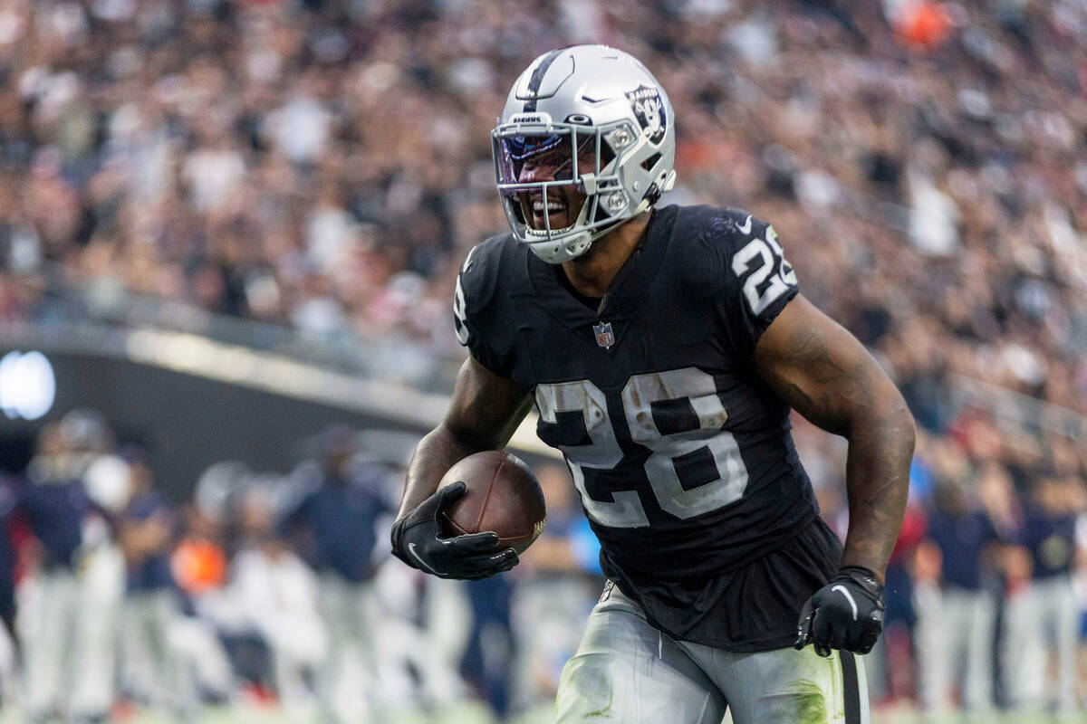 Raiders running back Josh Jacobs (28) scores his third touchdown of the game against the Housto ...