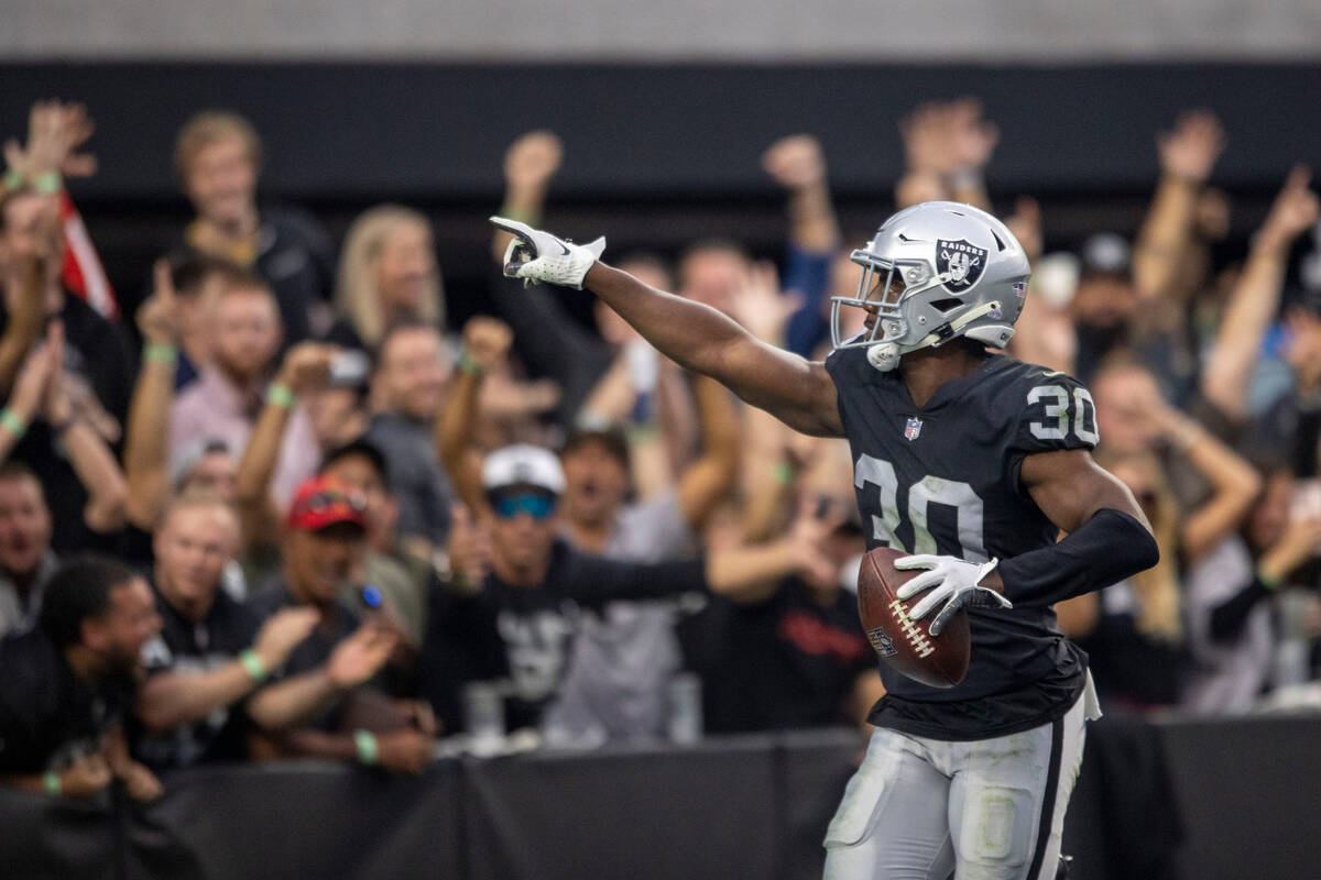 Raiders safety Duron Harmon (30) points to the crowd after scoring a touchdown following an int ...