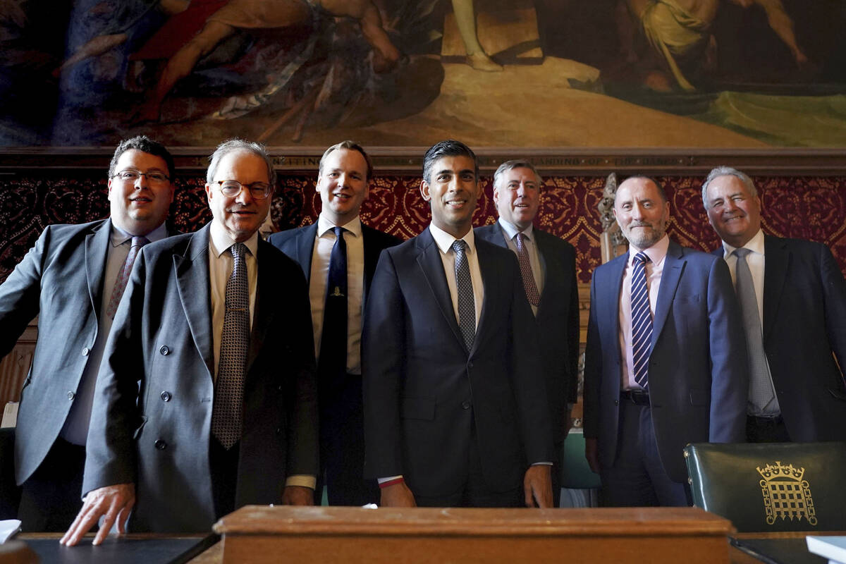 Britain's Rishi Sunak, centre, poses for a photo with members of the 1922 Committee, in the Hou ...