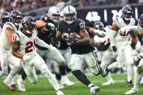 Raiders running back Josh Jacobs (28) runs the ball against the Houston Texans during the secon ...