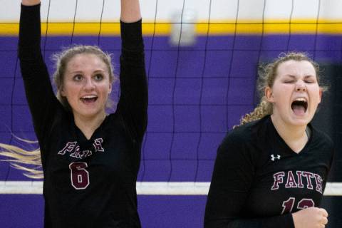 Faith Lutheran's Bianca Richardson (6) and Delaney Wilson (12) celebrate a point scored during ...