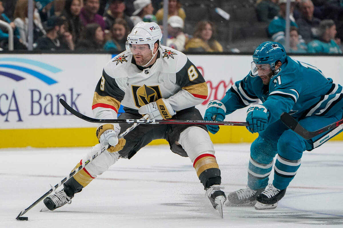 San Jose Sharks center Luke Kunin (11) chases after Vegas Golden Knights center Phil Kessel (8) ...