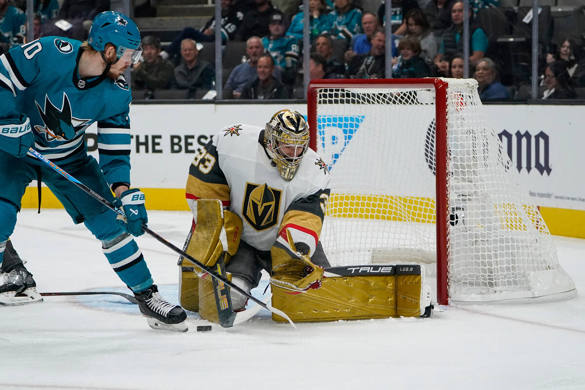 Vegas Golden Knights goaltender Adin Hill (33) blocks a shot by San Jose Sharks left wing Evgen ...