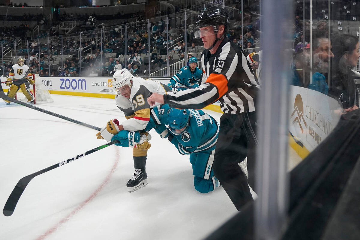 Vegas Golden Knights right wing Reilly Smith (19) and San Jose Sharks defenseman Matt Benning ( ...