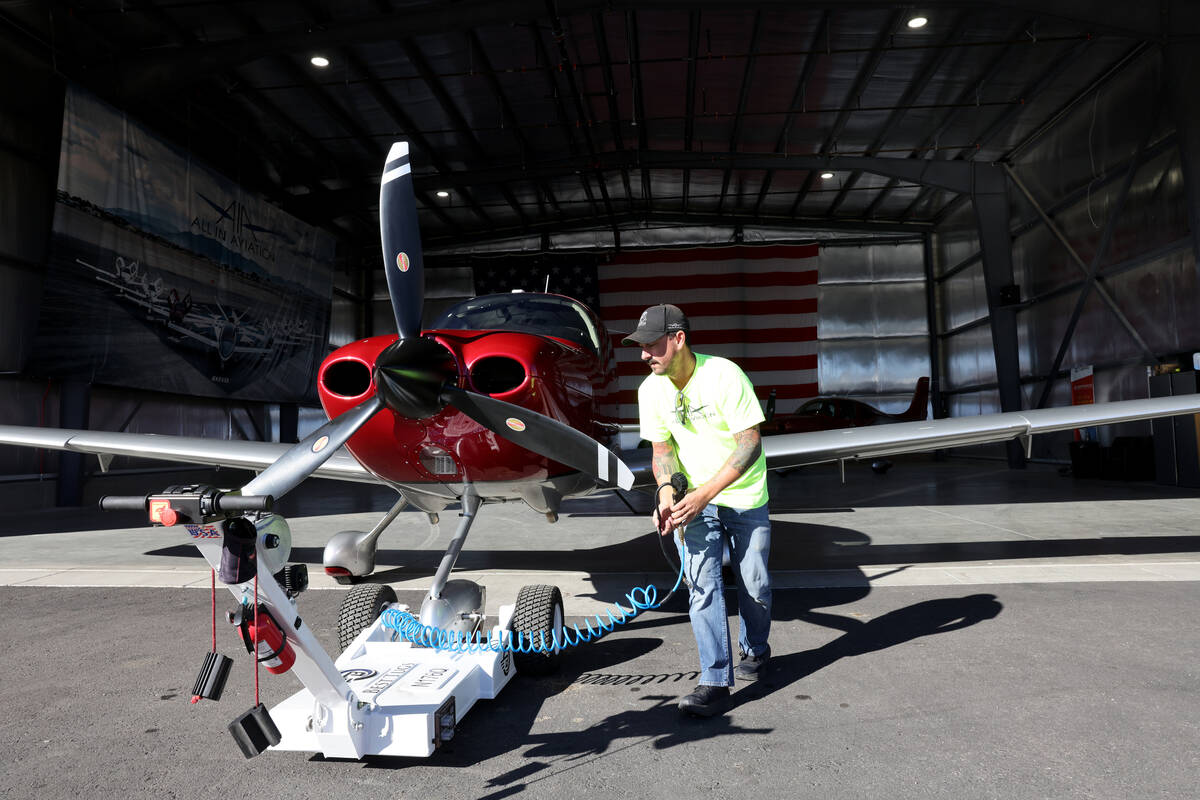 Aaron Rees, flight line manager at All In Aviation flight school, prepares a plane for a studen ...