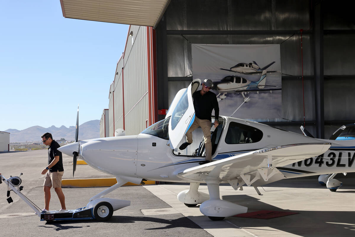 Certified Flight Instructor Aaron Adams, left, prepares for a student flight with Chris Bless o ...