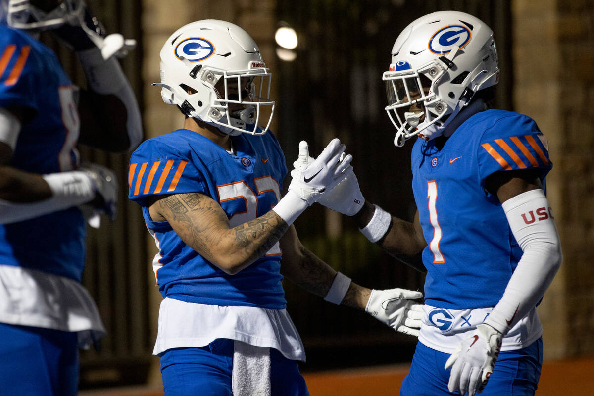 Bishop Gorman’s Trech Kekahuna (23) and Zachariah Branch (1) celebrate a touchdown during a h ...