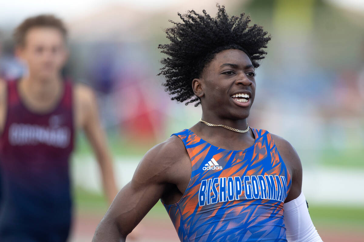 Bishop Gorman's Zachariah Branch runs through the finish line after winning the boys 200 meter ...