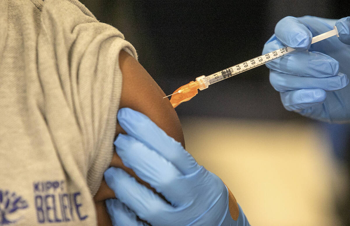 FILE - Medical personnel vaccinate students at a school in New Orleans on Tuesday, Jan. 25, 202 ...