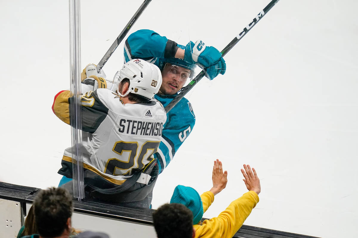 Vegas Golden Knights center Chandler Stephenson (20) is checked by San Jose Sharks defenseman M ...