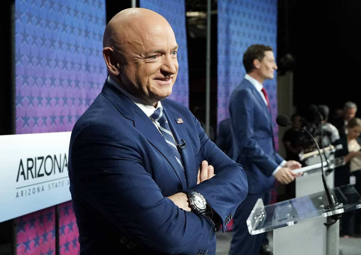 Arizona Democratic Sen. Mark Kelly, left, smiles as he stands on stage with Republican challeng ...