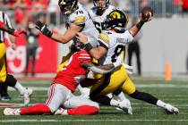 Ohio State linebacker Steele Chambers, left, forces Iowa quarterback Alex Padilla to throw an i ...