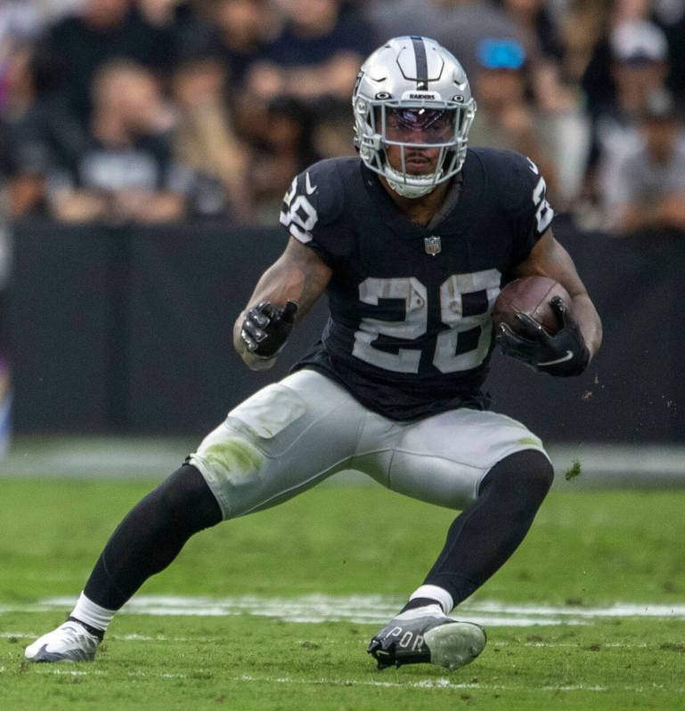 Raiders running back Josh Jacobs (28) runs against the Houston Texans during the first half of ...