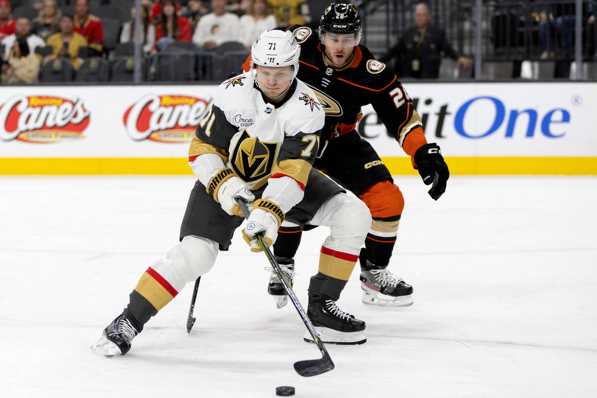 Golden Knights center William Karlsson (71) receives a pass while Ducks defenseman Nathan Beaul ...