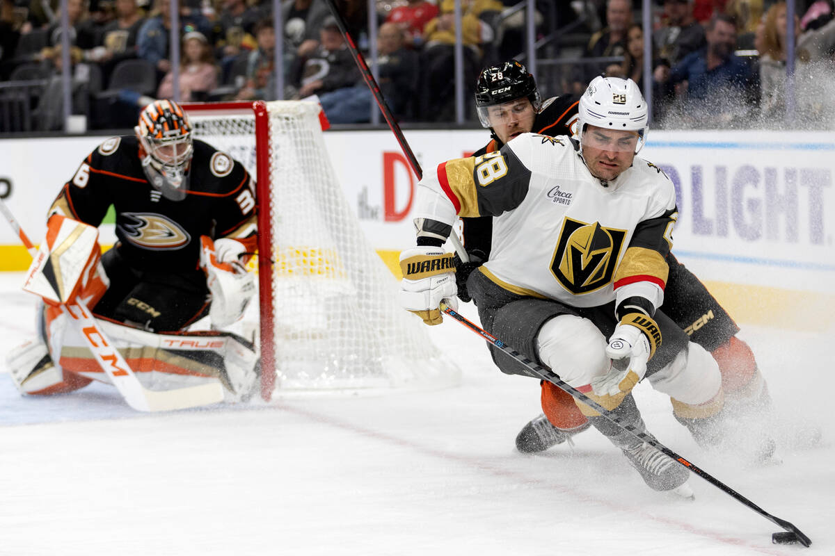 Golden Knights left wing William Carrier (28) attempts to redirect the puck while Ducks defense ...