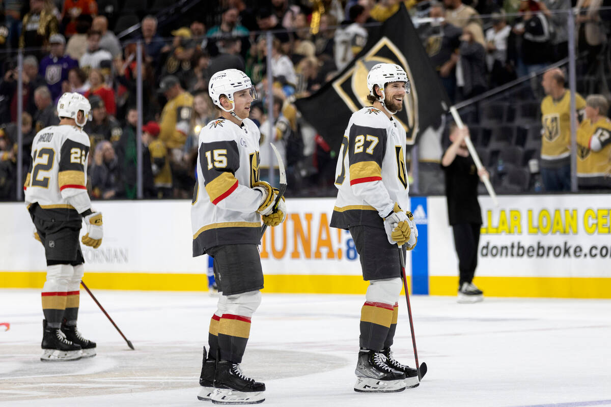 Golden Knights center Jake Leschyshyn (15) and Golden Knights defenseman Shea Theodore (27) ska ...