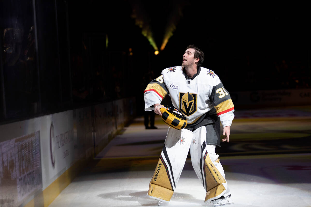 Golden Knights goaltender Logan Thompson (36) throws a team pillow to the crowd while he is rec ...