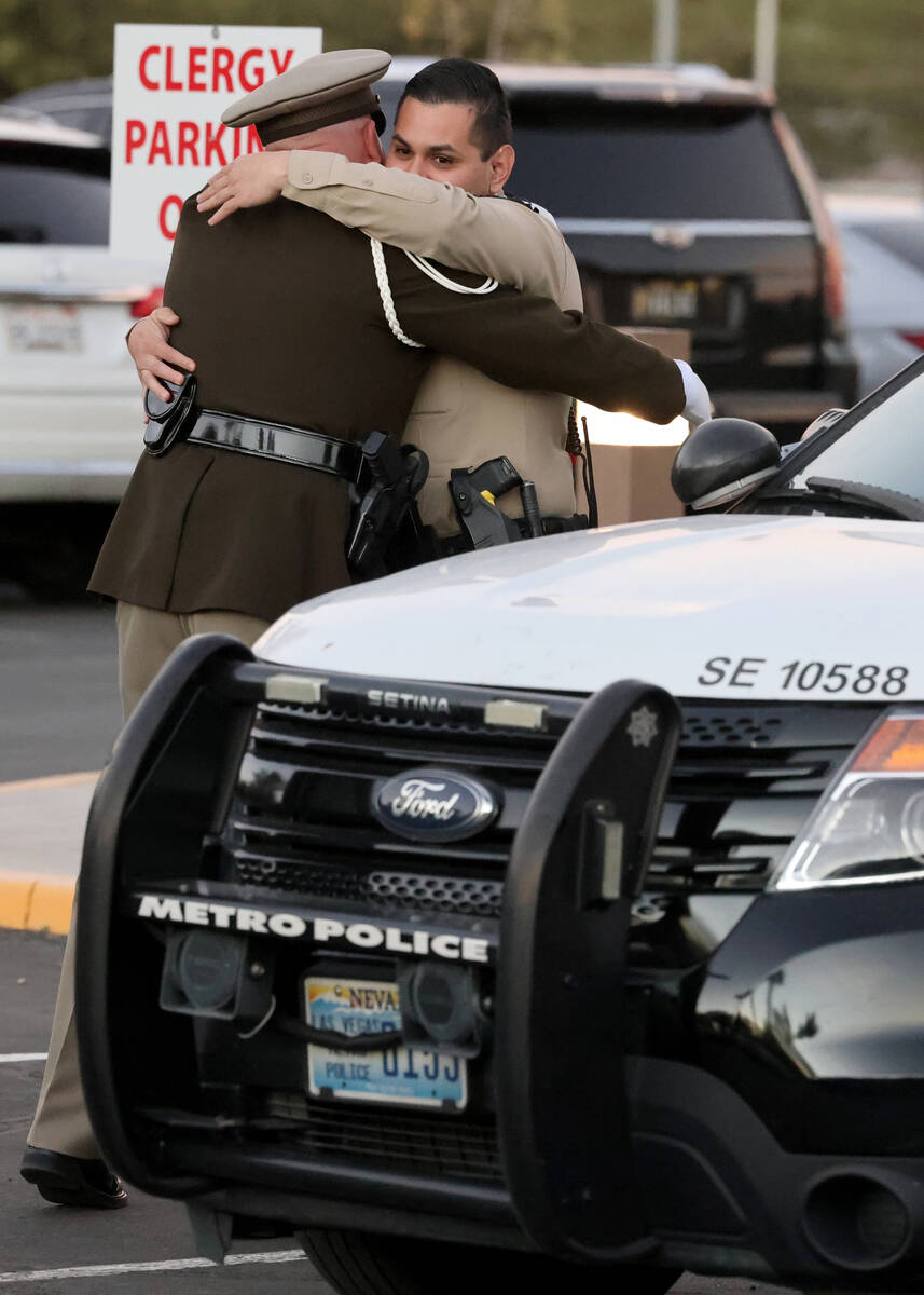 Officers hug during public visitation for fallen Las Vegas police officer Truong Thai at King D ...