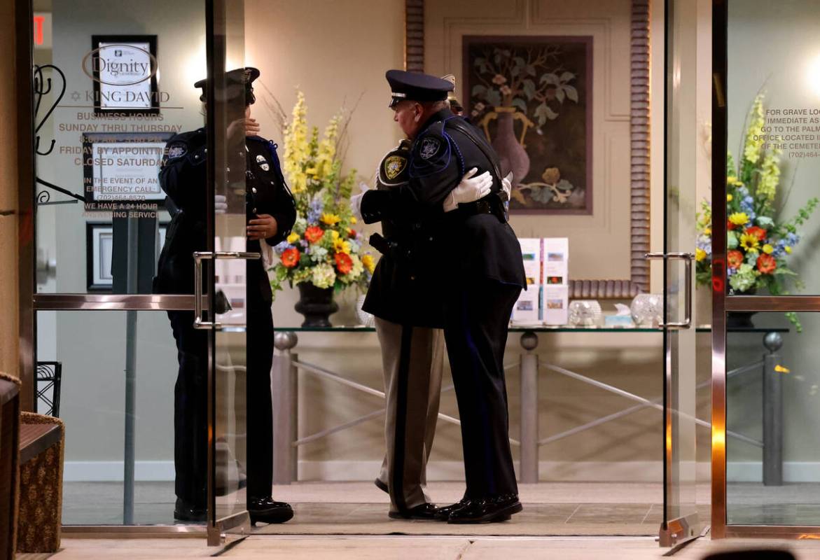 Officers hug during public visitation for fallen Las Vegas police officer Truong Thai at King D ...