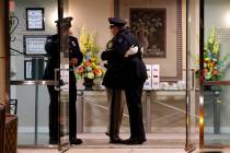 Officers hug during public visitation for fallen Las Vegas police officer Truong Thai at King D ...