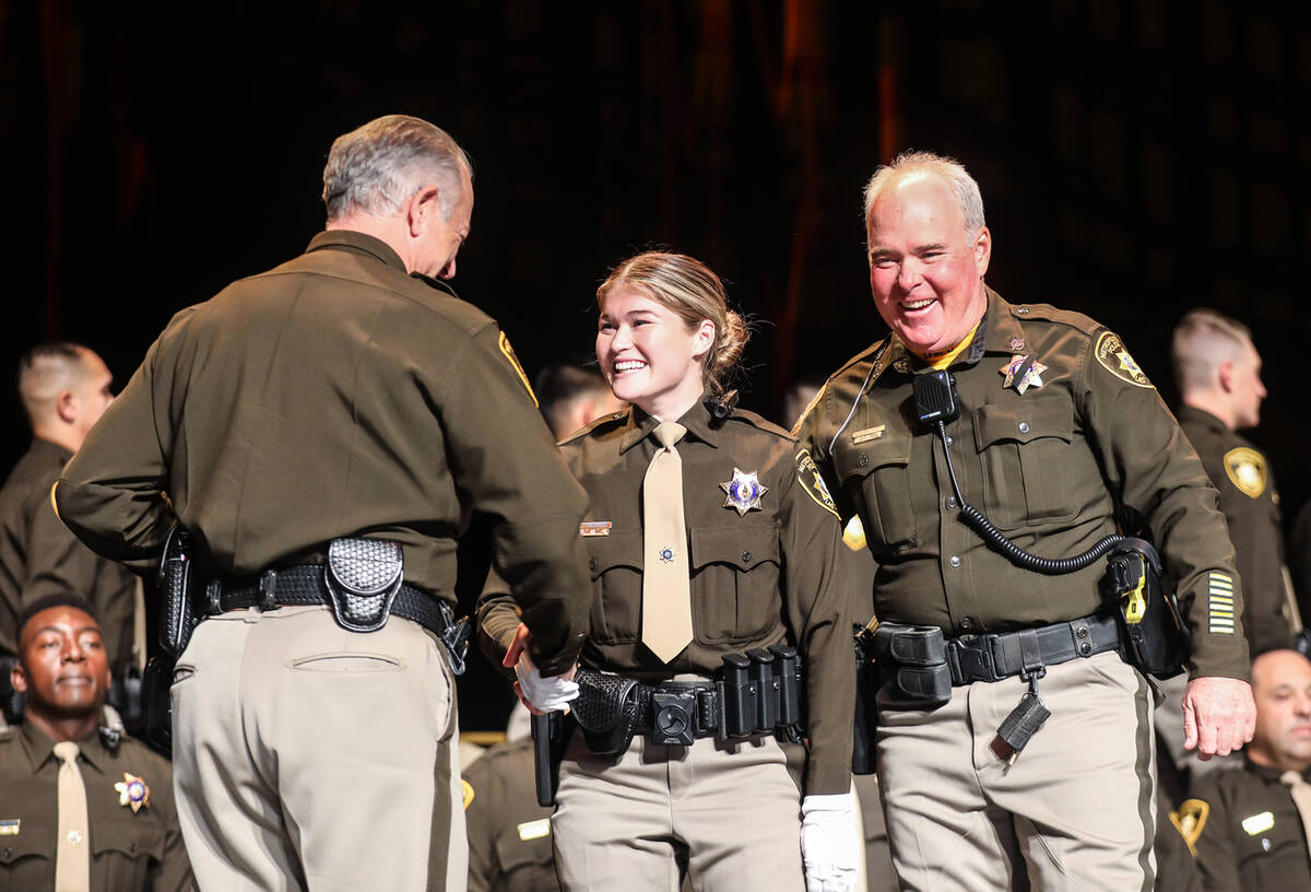 Officer Stephen Kircher, right, stands with his daughter and academy graduate Kirsten Kircher, ...