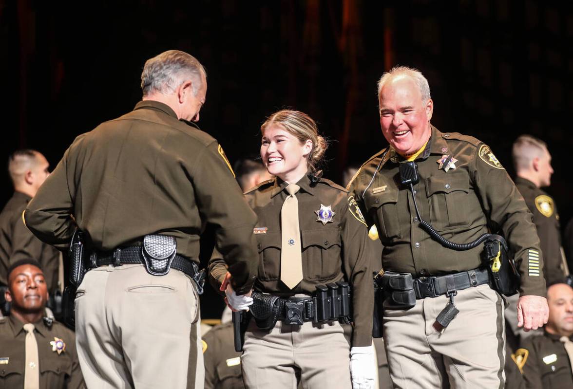 Officer Stephen Kircher, right, stands with his daughter and academy graduate Kirsten Kircher, ...