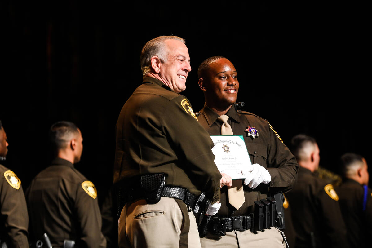 Clark Country Sheriff Joe Lombardo, left, poses for a picture with academy graduate Kendrick Bo ...