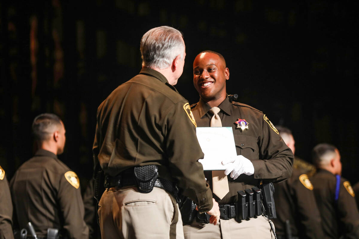 Clark Country Sheriff Joe Lombardo, left, congratulates academy graduate Kendrick Bourne Jr. at ...