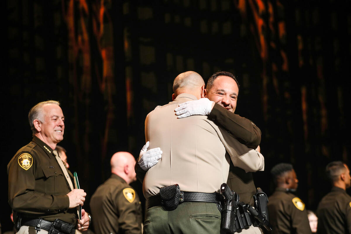 Los Angeles Country Sheriff Ciro Racowschi, left, hugs his nephew Luis Campos after presenting ...