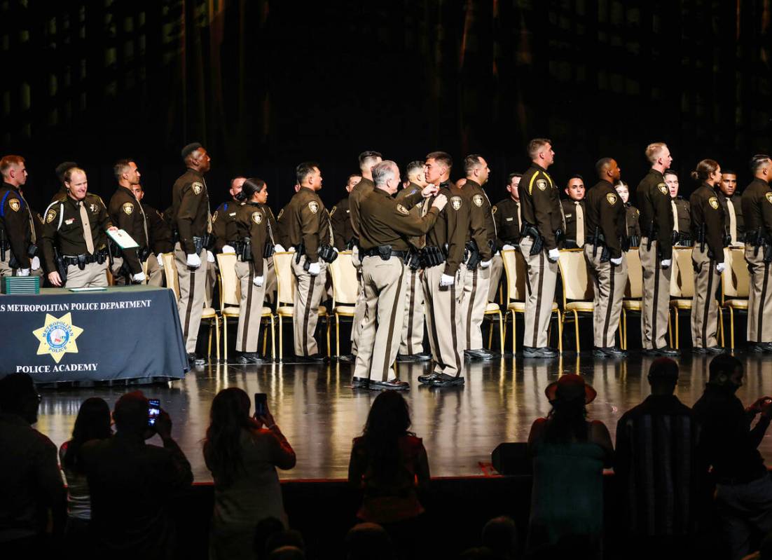 Clark Country Sheriff Joe Lombardo presents a badge to Nicolas Greybull at the Metropolitan Pol ...