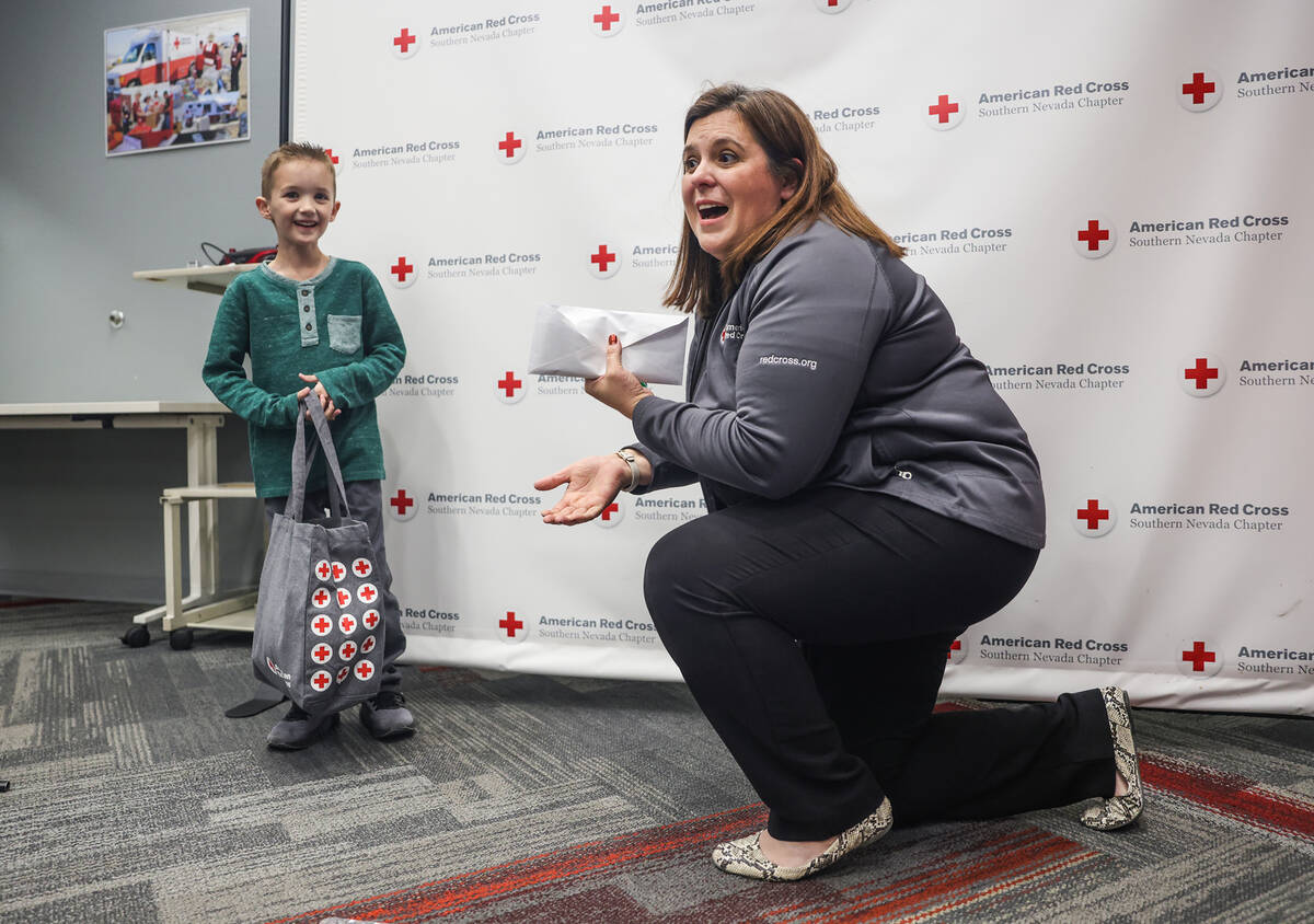 Henry Williams, 6, left, stands with Rachel Flanigan, executive director of the Red Cross of So ...